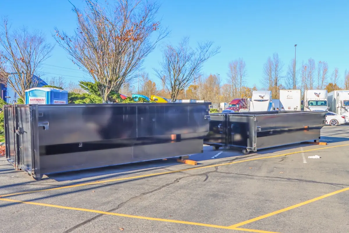 Professional dumpster rental service with roll-off container on residential driveway in Waimea